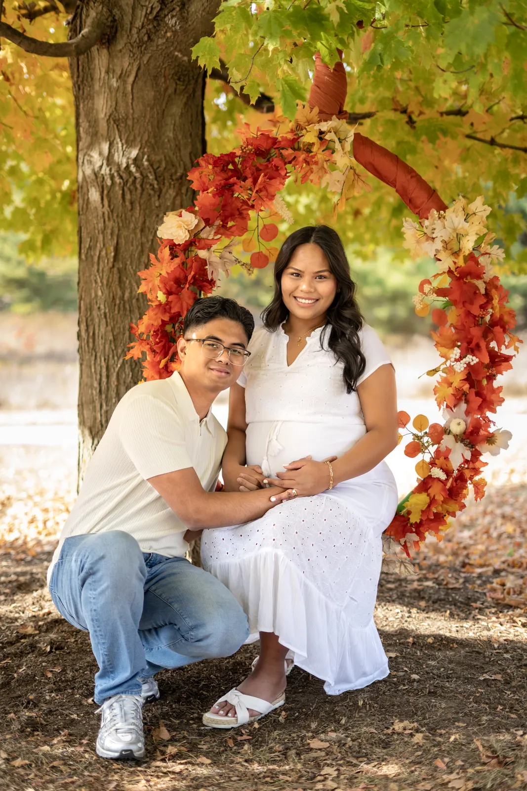 Marianne Fall Pictorials expecting parents on fall swing