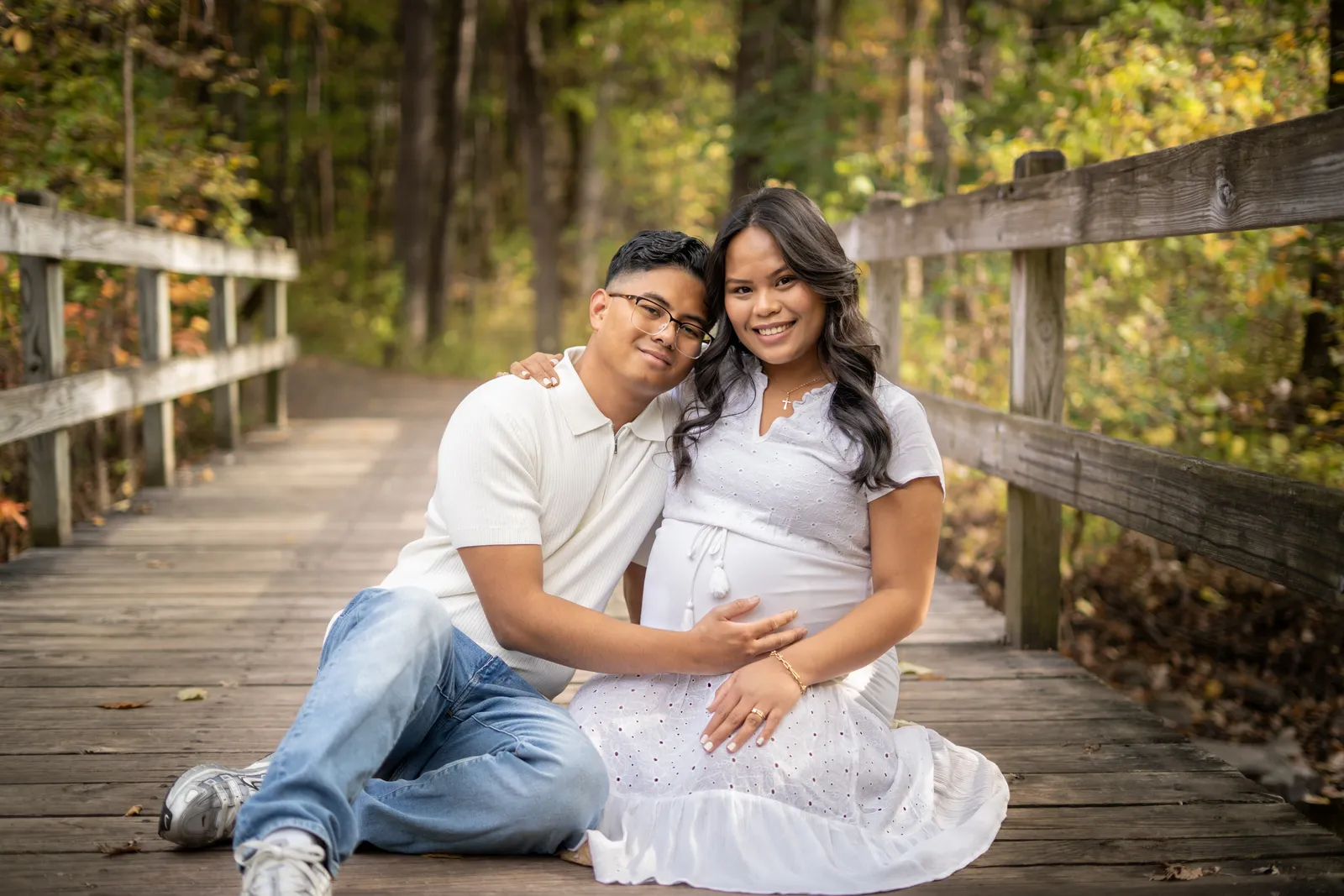 Marianne Fall Pictorials expecting parents seated on dock